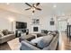 Comfortable living room with a gray sectional, ceiling fan, hardwood floors, and a fireplace at 14067 Hudson St, Thornton, CO 80602