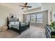 Spacious main bedroom with tray ceiling, large windows, and a ceiling fan at 14067 Hudson St, Thornton, CO 80602