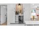 Stylish bar area with a wine cooler, custom cabinets, and elegant lighting perfect for entertaining at 4405 Gardenia St, Golden, CO 80403