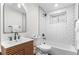 Bathroom featuring modern fixtures, sleek subway tiles, a stylish vanity, and a combined tub and shower at 4405 Gardenia St, Golden, CO 80403