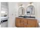 Bathroom featuring double vanity, modern lighting fixtures, and shower with white subway tile at 4405 Gardenia St, Golden, CO 80403