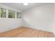 Bright and airy bedroom with beautiful hardwood floors and ample natural light from the large windows at 4405 Gardenia St, Golden, CO 80403