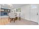 Bright dining area with wood floors and seating for four, with fireplace in adjacent room at 4405 Gardenia St, Golden, CO 80403