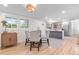 Bright dining area with wood floors and seating for four, located adjacent to the updated kitchen area at 4405 Gardenia St, Golden, CO 80403