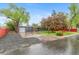 Exterior showcasing a one-story home with mature trees, fresh landscaping, and an attached garage at 4405 Gardenia St, Golden, CO 80403
