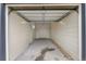 Spacious garage with neutral walls, offering ample storage and parking, and a separate door at 4405 Gardenia St, Golden, CO 80403