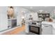 Modern kitchen with stainless steel appliances, white cabinets and open to the dining and living area at 4405 Gardenia St, Golden, CO 80403