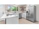 Beautiful updated kitchen with stainless steel appliances, white cabinetry and tile backsplash at 4405 Gardenia St, Golden, CO 80403