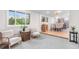 Open-concept living room with light-colored walls, hardwood floors, and seamless flow to the dining and kitchen area at 4405 Gardenia St, Golden, CO 80403
