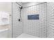 Stylish shower featuring black fixtures and sleek white subway tile with a unique mosaic tile accent niche at 4405 Gardenia St, Golden, CO 80403