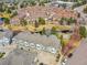 Aerial view of townhomes, surrounded by a pond, walking paths, and lush landscaping, creating a community at 9085 E Phillips Dr, Centennial, CO 80112