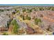 Aerial view showcases townhomes surrounding a scenic pond with a walking path and landscaping at 9085 E Phillips Dr, Centennial, CO 80112