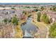 Aerial view of townhomes surrounding a pond with a walking path and landscaping; enhanced community at 9085 E Phillips Dr, Centennial, CO 80112