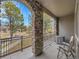 Enjoy scenic views from this spacious balcony with stylish stone arch and black metal railing at 9085 E Phillips Dr, Centennial, CO 80112