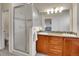 Bright bathroom featuring a double sink vanity with granite countertops and a walk-in shower at 9085 E Phillips Dr, Centennial, CO 80112