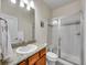 Bright bathroom with a walk-in shower, vanity and sink with granite countertop and tile backsplash at 9085 E Phillips Dr, Centennial, CO 80112