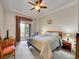 Bright bedroom with ceiling fan, sliding glass doors to balcony, and comfortable furniture at 9085 E Phillips Dr, Centennial, CO 80112
