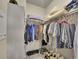 Organized walk-in closet with ample hanging space, shelves and storage for shoes and personal items at 9085 E Phillips Dr, Centennial, CO 80112