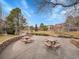Community picnic tables with stone accents next to the pond for outdoor gatherings at 9085 E Phillips Dr, Centennial, CO 80112