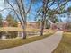 Picturesque community walking path by the pond with mature trees and lush green spaces at 9085 E Phillips Dr, Centennial, CO 80112