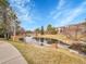 Water feature in neighborhood with walking paths, grass, and trees at 9085 E Phillips Dr, Centennial, CO 80112
