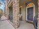 Charming entrance with stone pillars and covered porch and a dark blue front door at 9085 E Phillips Dr, Centennial, CO 80112