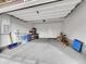 A clean, spacious garage with ample storage space, a side door, and a well-maintained concrete floor at 9085 E Phillips Dr, Centennial, CO 80112