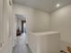 Hallway featuring neutral walls, carpet flooring, and an open doorway leading to the living area with outdoor access at 9085 E Phillips Dr, Centennial, CO 80112