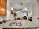 Kitchen sink and countertop with view of dining and living spaces, showcasing an open-concept design at 9085 E Phillips Dr, Centennial, CO 80112