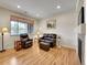 Comfortable living room featuring modern lighting, wood floors, and cozy furniture at 9085 E Phillips Dr, Centennial, CO 80112