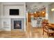 Open-concept living space connecting fireplace, kitchen and dining room at 9085 E Phillips Dr, Centennial, CO 80112