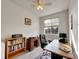 Bright office with a ceiling fan, large window, desk and shelves for books and personal items at 9085 E Phillips Dr, Centennial, CO 80112