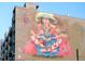 Large mural on building exterior featuring deity at 3198 Blake St # 402, Denver, CO 80205