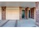 Welcoming entrance featuring a front door, a garage, and brick columns for curb appeal at 2182 Eagle Ave, Superior, CO 80027