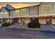 Row of townhomes with attached garages, brick accents, and landscaping at sunset at 2182 Eagle Ave, Superior, CO 80027