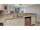 Kitchen featuring granite countertops, stainless steel dishwasher, and sink overlooking the living area at 2182 Eagle Ave, Superior, CO 80027