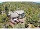 Aerial view of home showcasing the wooden deck, mature landscaping, and the surrounding tree coverage at 6252 King Dr, Evergreen, CO 80439