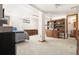 Open basement with a bed, dresser, hutch, carpet and an attached bathroom through a wooden door at 6252 King Dr, Evergreen, CO 80439