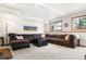 Cozy basement with a large sectional sofa, carpet, and mountain view window at 6252 King Dr, Evergreen, CO 80439