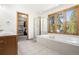 Light-filled bathroom with soaking tub, shower and walk-in closet at 6252 King Dr, Evergreen, CO 80439