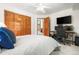 A bedroom with large windows, closet doors and a desk at 6252 King Dr, Evergreen, CO 80439