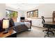 Inviting bedroom featuring carpet, natural light and calming wooded views at 6252 King Dr, Evergreen, CO 80439