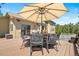 Relaxing deck with dining set, seating, spa, and views of a lush forest at 6252 King Dr, Evergreen, CO 80439