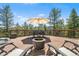 Stunning deck with fire pit, dining table, seating, and views of surrounding lush evergreen trees at 6252 King Dr, Evergreen, CO 80439