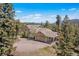 Secluded home with an attached two-car garage, surrounded by lush forest and mountain views at 6252 King Dr, Evergreen, CO 80439
