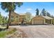 Charming home exterior featuring an attached garage with carport and well-maintained yard at 6252 King Dr, Evergreen, CO 80439