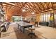 Large carpeted garage interior with exposed wood framework, ping pong table and shelving at 6252 King Dr, Evergreen, CO 80439