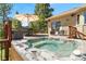 Lovely deck with a hot tub, dining table, seating, and views of the backyard at 6252 King Dr, Evergreen, CO 80439