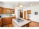 An updated kitchen island with a cooktop and plenty of cabinets at 6252 King Dr, Evergreen, CO 80439