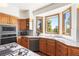 Charming kitchen with wood cabinetry and scenic views from the bay windows at 6252 King Dr, Evergreen, CO 80439